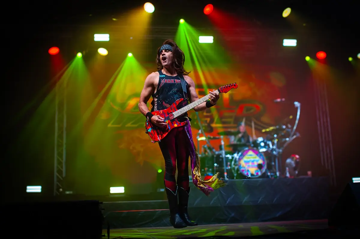 Steel Panther guitarist performing live on stage