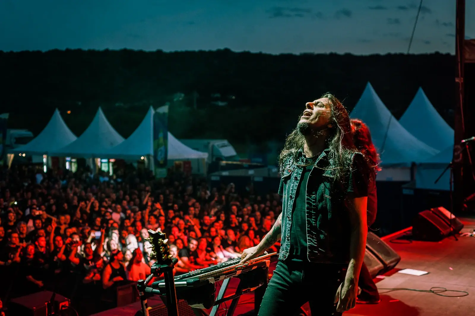 Firewind guitarist performing at an outdoor festival